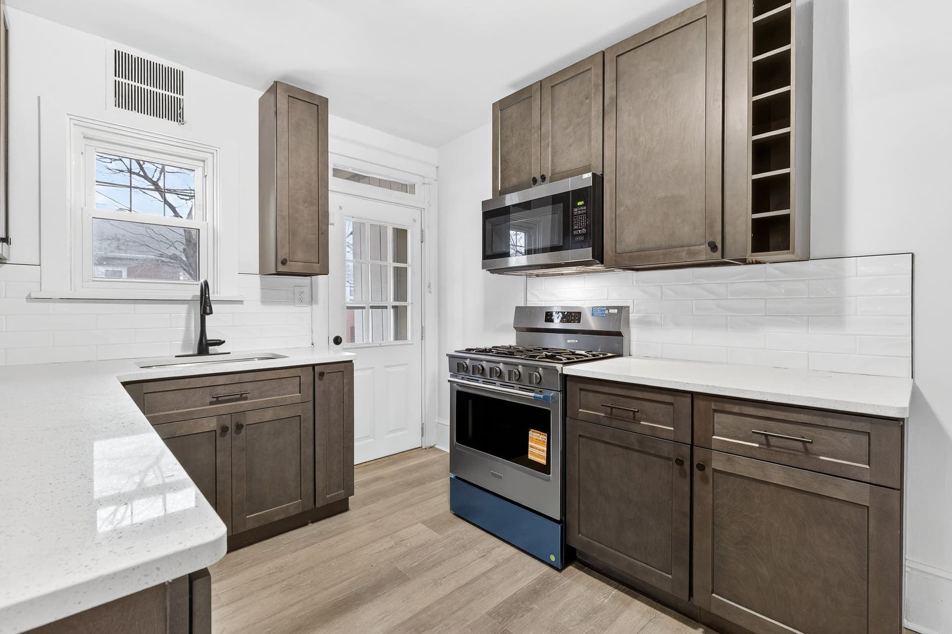 Renovated kitchen — taupe cabinetry, subway tile — New Holland Ave